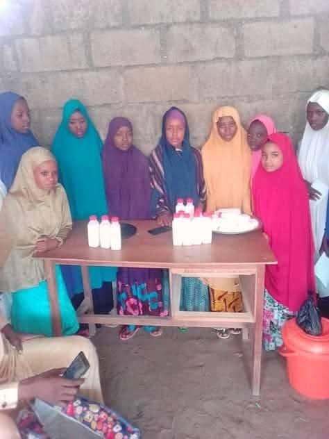 Young women with packaged yogurt produced in training
